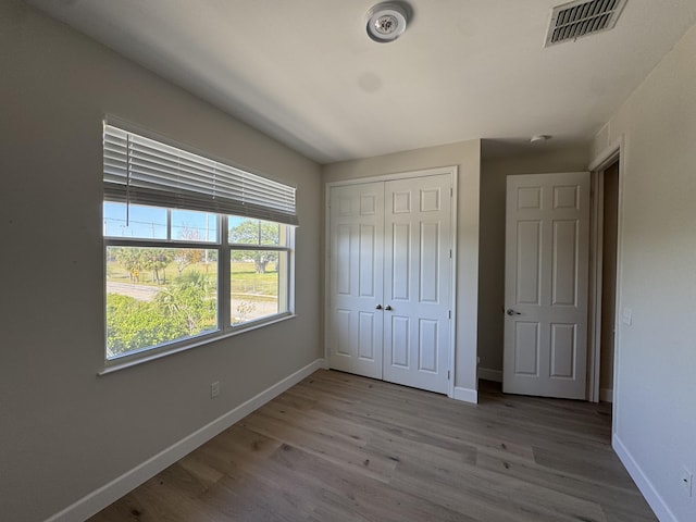 2799 Saranac Ave, West Palm Beach, FL 33409 - unfurnished bedroom with wood finished floors and a closet