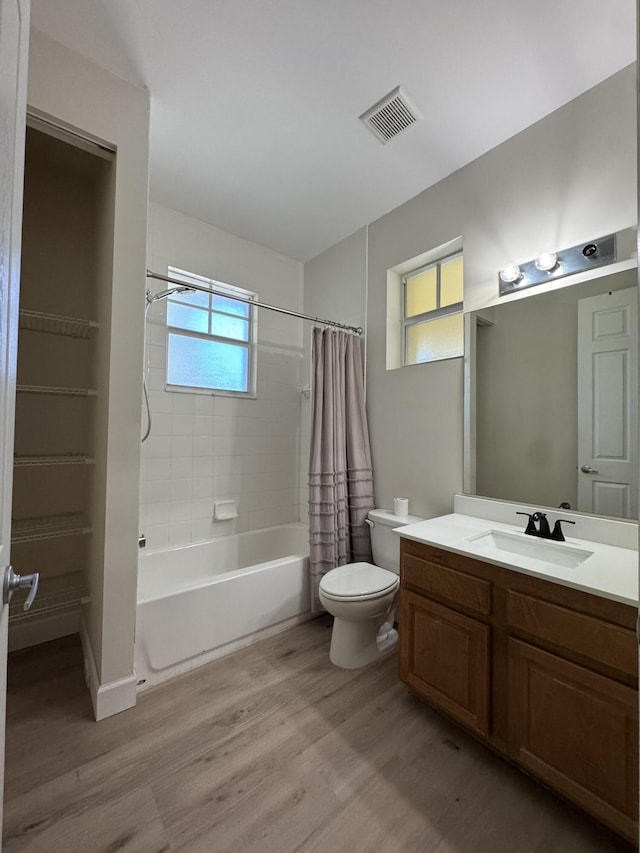 2799 Saranac Ave, West Palm Beach, FL 33409 - bathroom featuring shower / bath combo with shower curtain, wood finished floors, and vanity