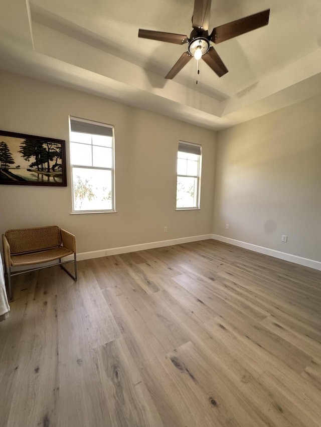 2799 Saranac Ave, West Palm Beach, FL 33409 - empty room with a raised ceiling, wood finished floors, and a ceiling fan