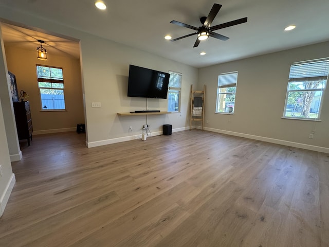 2799 Saranac Ave, West Palm Beach, FL 33409 - unfurnished living room with plenty of natural light, wood finished floors, a ceiling fan, and recessed lighting