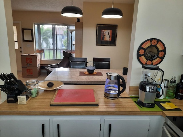 3531 Tall Pine Way Unit B-2, Greenacres, FL 33463 - kitchen with electric range, hanging light fixtures, light countertops, and white cabinetry