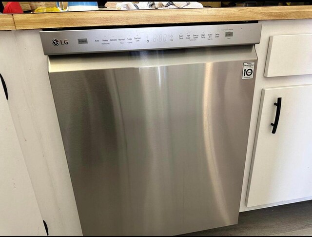 3531 Tall Pine Way Unit B-2, Greenacres, FL 33463 - detailed view of stainless steel dishwasher and wood finished floors