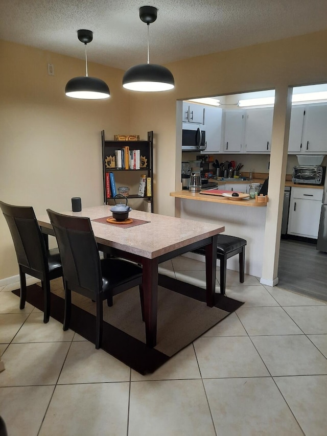 3531 Tall Pine Way Unit B-2, Greenacres, FL 33463 - dining area featuring a textured ceiling and light tile patterned flooring