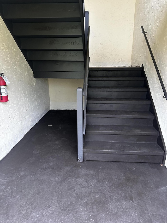 3531 Tall Pine Way Unit B-2, Greenacres, FL 33463 - staircase with a textured wall and concrete flooring
