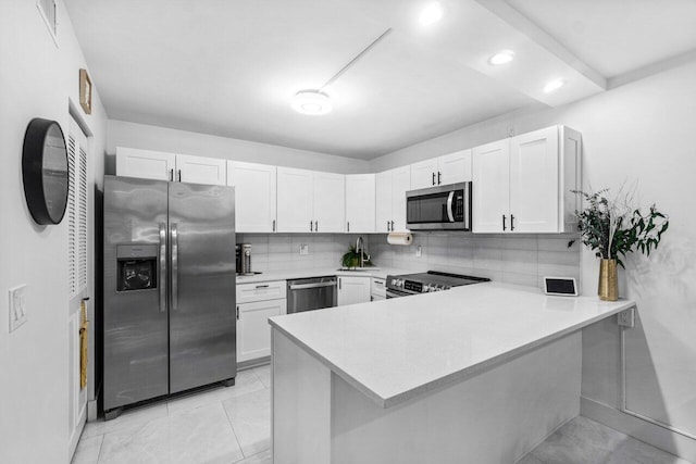 519 Shady Pine Way Unit C1, Greenacres, FL 33415 - kitchen with stainless steel appliances, a peninsula, light countertops, white cabinetry, and backsplash