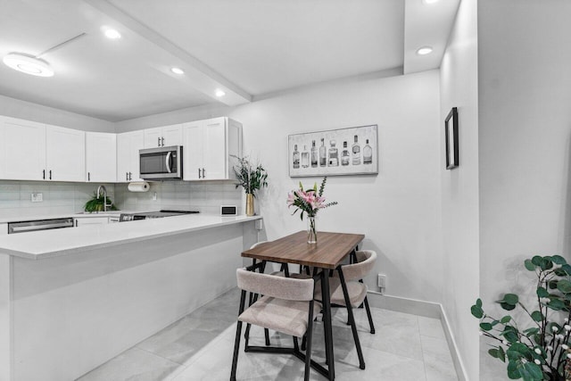 519 Shady Pine Way Unit C1, Greenacres, FL 33415 - kitchen with appliances with stainless steel finishes, light countertops, white cabinetry, recessed lighting, and backsplash