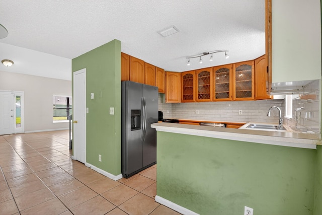 3 Ripley Way, Boynton Beach, FL 33426 - kitchen featuring stainless steel refrigerator with ice dispenser, a peninsula, tasteful backsplash, light tile patterned floors, and glass insert cabinets