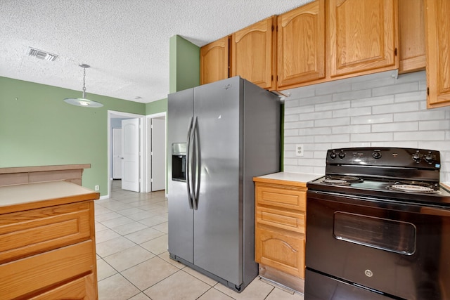 3 Ripley Way, Boynton Beach, FL 33426 - kitchen featuring black range with electric stovetop, stainless steel fridge, backsplash, a textured ceiling, and light tile patterned floors