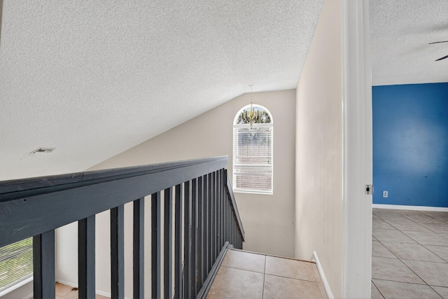 3 Ripley Way, Boynton Beach, FL 33426 - staircase featuring a textured ceiling, tile patterned flooring, and lofted ceiling