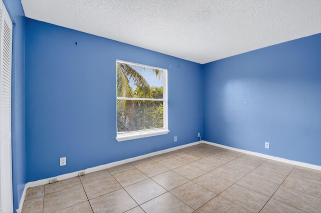 3 Ripley Way, Boynton Beach, FL 33426 - tiled empty room with a textured ceiling and baseboards