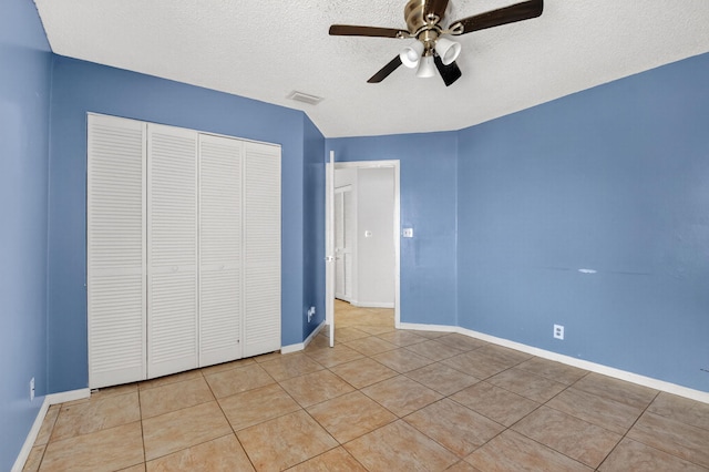 3 Ripley Way, Boynton Beach, FL 33426 - unfurnished bedroom with light tile patterned floors, a closet, a textured ceiling, and ceiling fan