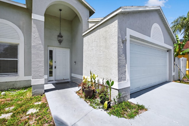 3 Ripley Way, Boynton Beach, FL 33426 - doorway to property with stucco siding and driveway