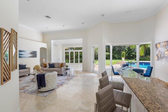 16164 Bridlewood Cir, Delray Beach, FL 33445 - living room with a towering ceiling, healthy amount of natural light, crown molding, arched walkways, and light marble finish flooring