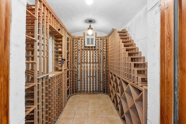 16164 Bridlewood Cir, Delray Beach, FL 33445 - wine area with a textured ceiling, a textured wall, and tile patterned flooring