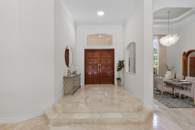 16164 Bridlewood Cir, Delray Beach, FL 33445 - foyer with marble tiled floors, a chandelier, crown molding, baseboards, and a high ceiling