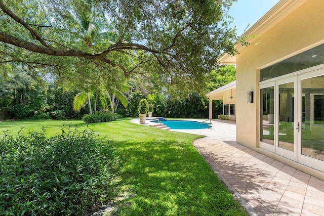16164 Bridlewood Cir, Delray Beach, FL 33445 - view of green lawn featuring french doors, a patio area, and an outdoor pool