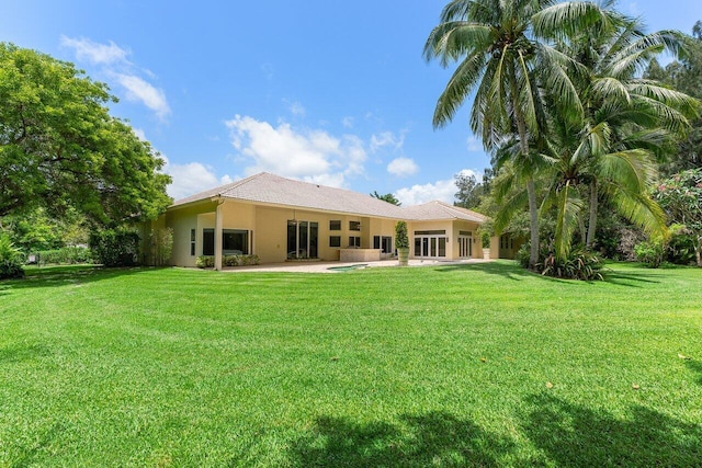 16164 Bridlewood Cir, Delray Beach, FL 33445 - back of house with a patio area, stucco siding, and a yard