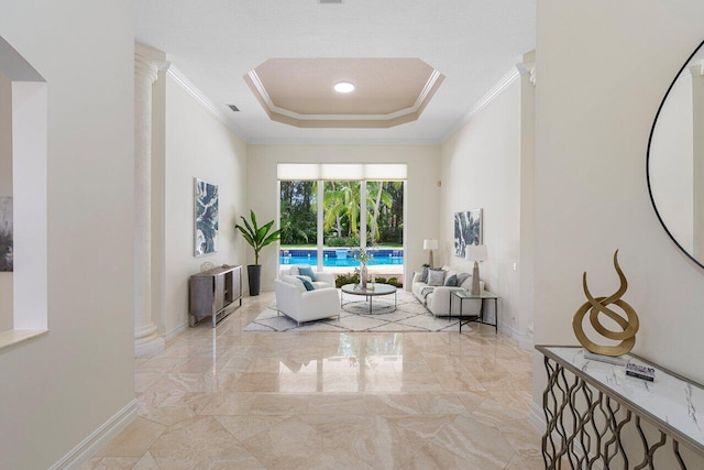 16164 Bridlewood Cir, Delray Beach, FL 33445 - hall featuring crown molding, a raised ceiling, marble tiled floors, baseboards, and ornate columns