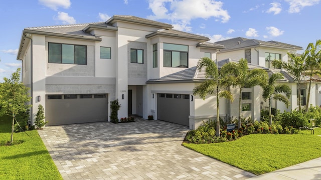 12870 Crane Xing, Palm Beach Gardens, FL 33412 - view of front of property with a garage, decorative driveway, stucco siding, a front yard, and a tiled roof