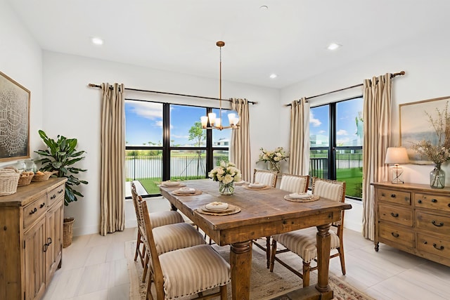 12870 Crane Xing, Palm Beach Gardens, FL 33412 - dining space with a water view, a chandelier, and light tile patterned floors