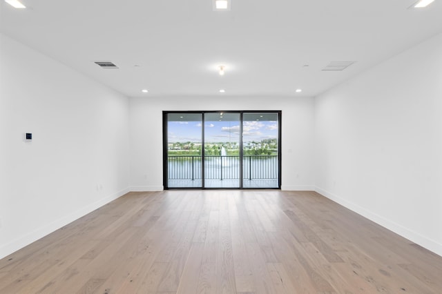 12870 Crane Xing, Palm Beach Gardens, FL 33412 - unfurnished room featuring light wood finished floors, a water view, and recessed lighting