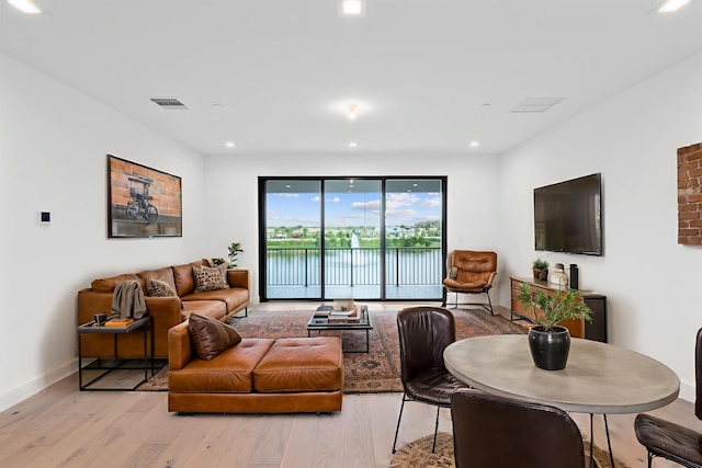12870 Crane Xing, Palm Beach Gardens, FL 33412 - living room featuring light wood finished floors and recessed lighting