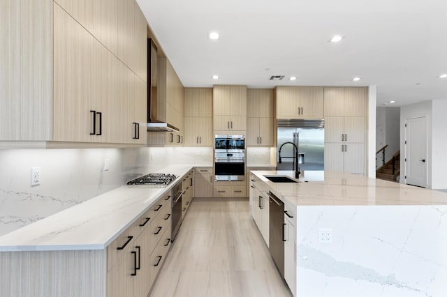 12870 Crane Xing, Palm Beach Gardens, FL 33412 - kitchen with modern cabinets, stainless steel appliances, light brown cabinets, a large island, and recessed lighting