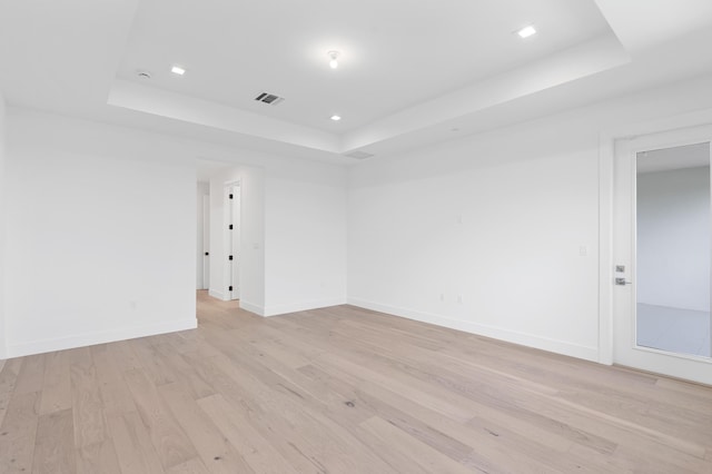 12870 Crane Xing, Palm Beach Gardens, FL 33412 - unfurnished room featuring a raised ceiling, light wood-style floors, and recessed lighting