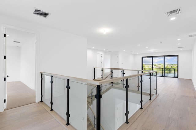 12870 Crane Xing, Palm Beach Gardens, FL 33412 - hall featuring an upstairs landing, light wood-style floors, and recessed lighting