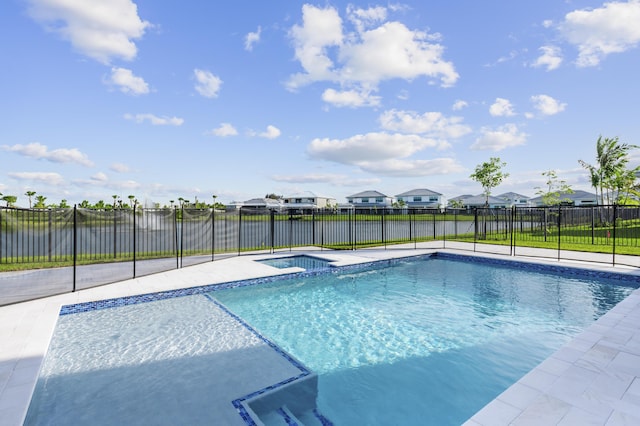 12870 Crane Xing, Palm Beach Gardens, FL 33412 - view of pool with a residential view, a water view, a pool with connected hot tub, and a fenced backyard