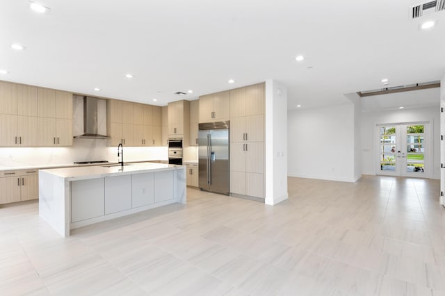 12870 Crane Xing, Palm Beach Gardens, FL 33412 - kitchen with built in refrigerator, wall chimney range hood, modern cabinets, and light countertops