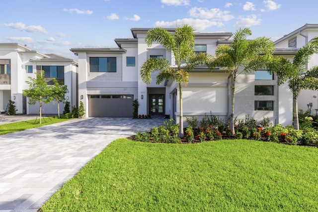 12870 Crane Xing, Palm Beach Gardens, FL 33412 - view of front of property with french doors, a garage, stucco siding, decorative driveway, and a front lawn