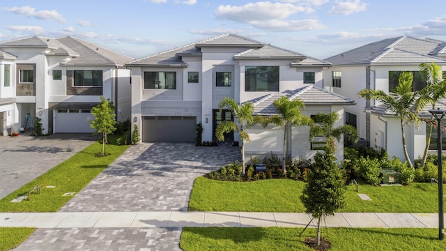 12870 Crane Xing, Palm Beach Gardens, FL 33412 - view of front of property featuring stucco siding, decorative driveway, a garage, and a tile roof