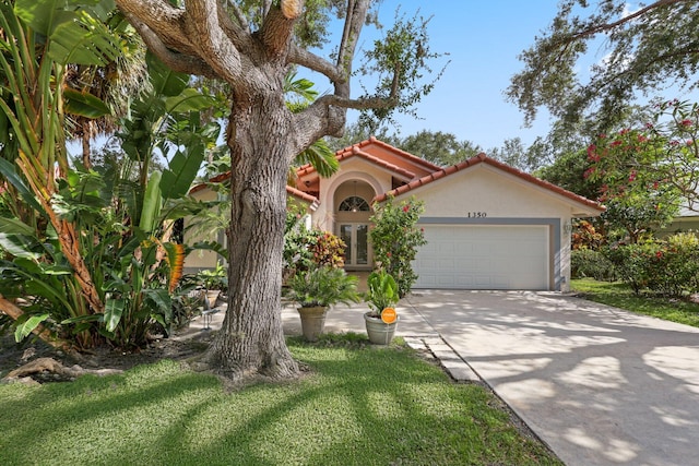 1350 SW 18th St, Boca Raton, FL 33486 - mediterranean / spanish-style home featuring stucco siding, an attached garage, driveway, and a tile roof