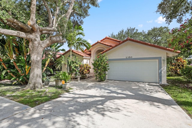 1350 SW 18th St, Boca Raton, FL 33486 - mediterranean / spanish-style house with a tiled roof, stucco siding, an attached garage, and concrete driveway