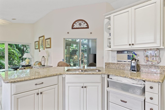1350 SW 18th St, Boca Raton, FL 33486 - kitchen featuring healthy amount of natural light, light stone counters, and white cabinetry