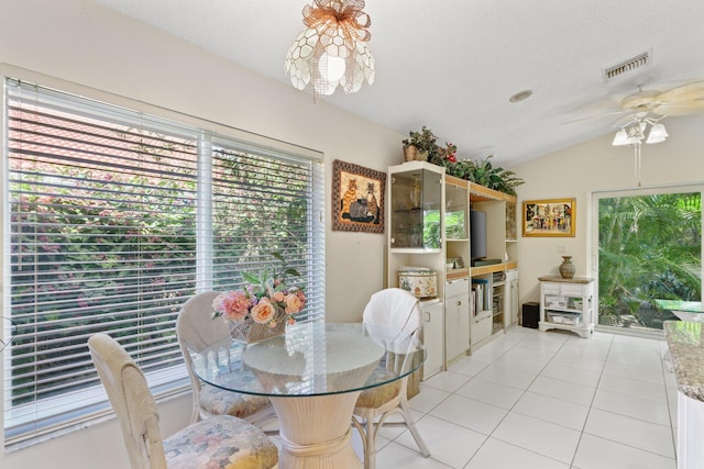 1350 SW 18th St, Boca Raton, FL 33486 - dining area with healthy amount of natural light, vaulted ceiling, light tile patterned floors, and a ceiling fan