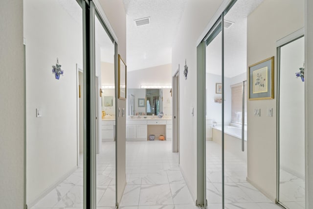 1350 SW 18th St, Boca Raton, FL 33486 - corridor with light marble finish flooring and a textured ceiling