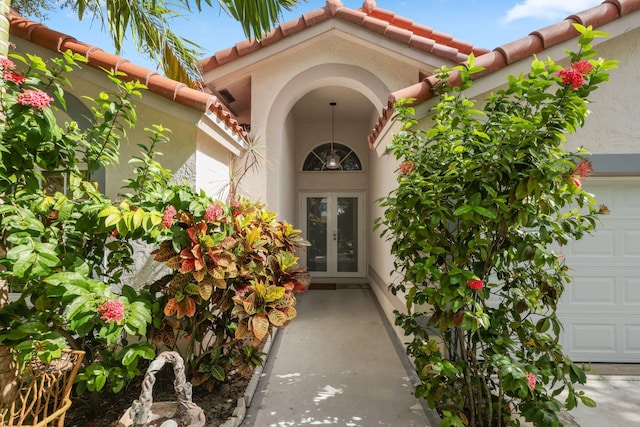 1350 SW 18th St, Boca Raton, FL 33486 - doorway to property with french doors, a tiled roof, and stucco siding