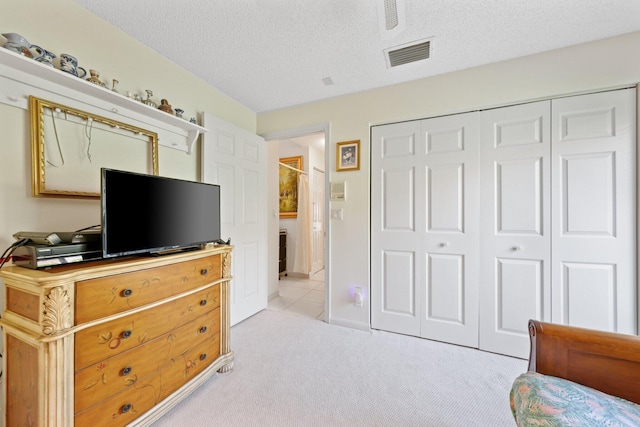 1350 SW 18th St, Boca Raton, FL 33486 - bedroom with light carpet, a closet, a textured ceiling, and a ceiling fan