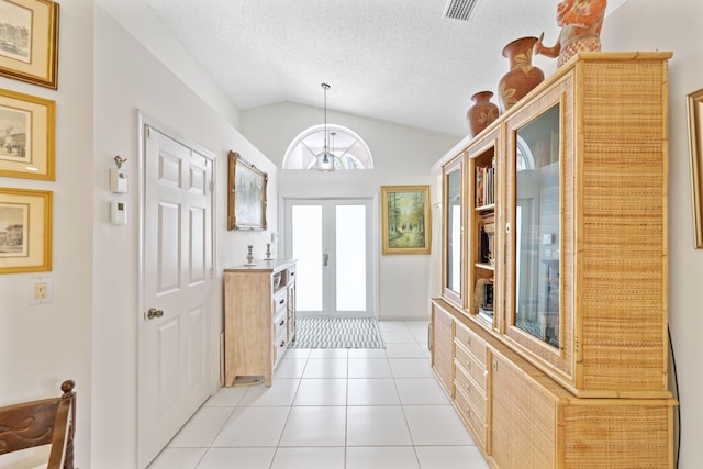 1350 SW 18th St, Boca Raton, FL 33486 - foyer featuring vaulted ceiling, light tile patterned flooring, and a textured ceiling