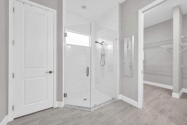 15187 Goldfinch Cir, Westlake, FL 33470 - bathroom with a shower stall, a walk in closet, and wood finished floors