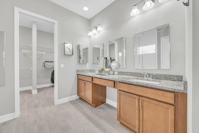 15187 Goldfinch Cir, Westlake, FL 33470 - full bath with double vanity, a walk in closet, and wood finished floors