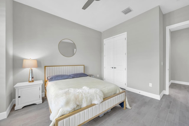 15187 Goldfinch Cir, Westlake, FL 33470 - bedroom with light wood finished floors, a closet, and a ceiling fan