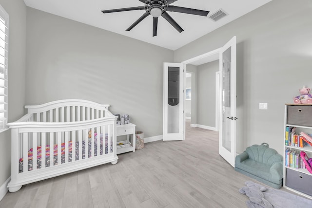 15187 Goldfinch Cir, Westlake, FL 33470 - bedroom featuring wood finished floors, a nursery area, french doors, and ceiling fan