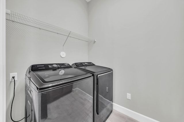 15187 Goldfinch Cir, Westlake, FL 33470 - washroom with washing machine and clothes dryer and baseboards