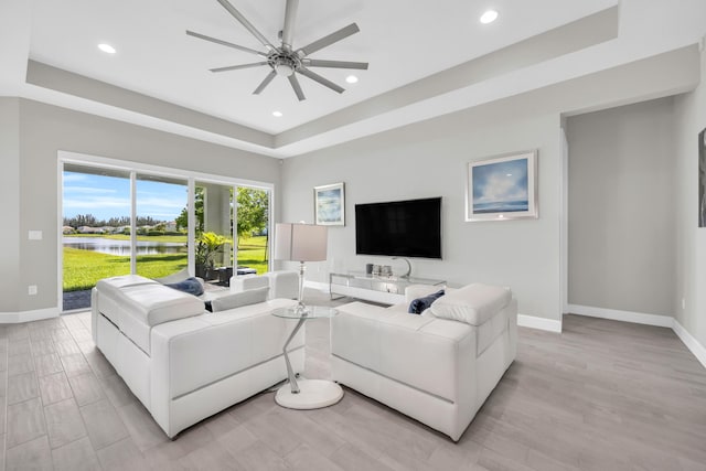 15187 Goldfinch Cir, Westlake, FL 33470 - living area featuring a tray ceiling, ceiling fan, recessed lighting, and light wood-type flooring