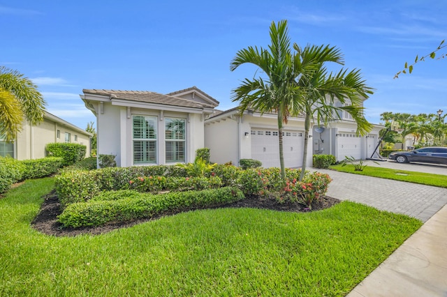 15187 Goldfinch Cir, Westlake, FL 33470 - single story home featuring stucco siding, driveway, a garage, and a front lawn