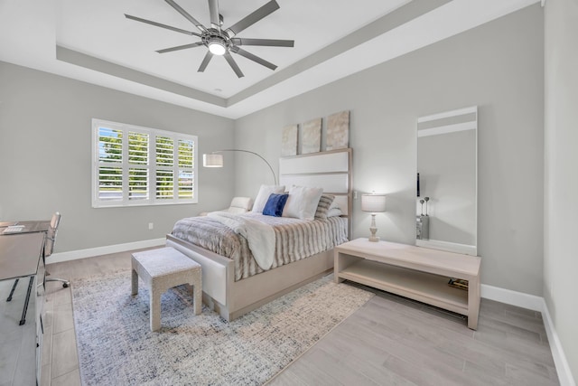 15187 Goldfinch Cir, Westlake, FL 33470 - bedroom with a tray ceiling, wood finished floors, and a ceiling fan