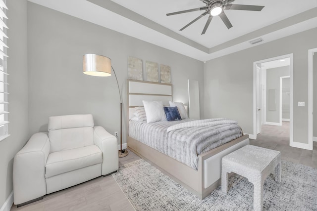 15187 Goldfinch Cir, Westlake, FL 33470 - bedroom with wood finished floors, a tray ceiling, and ceiling fan